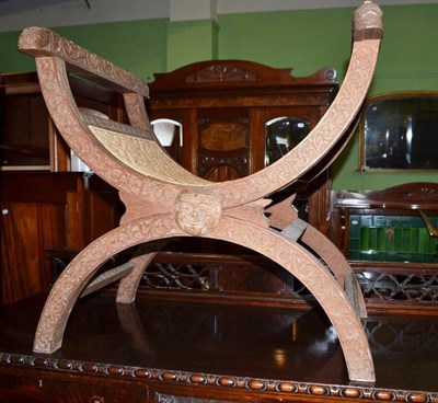 Lot 616 - Carved X-frame stool