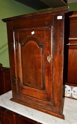 Lot 619 - An oak corner cupboard