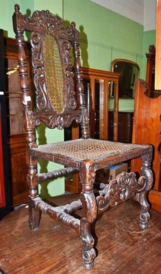 Lot 622 - A carved walnut cane seated high back chair, in 17th century style