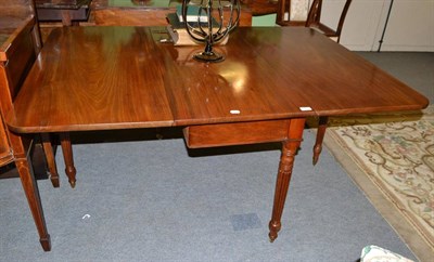 Lot 643 - A mahogany drop leaf dining table on reeded legs