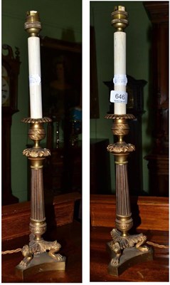 Lot 646 - A pair of reproduction Regency style brass table lamps