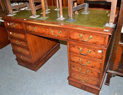 Lot 666 - A reproduction pedestal desk with a leather top