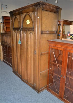 Lot 694 - A reproduction linen fold wardrobe, coffer, bookcase top and cupboard