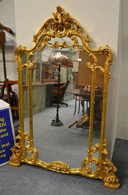 Lot 751 - A reproduction Rocco style gilt framed wall mirror