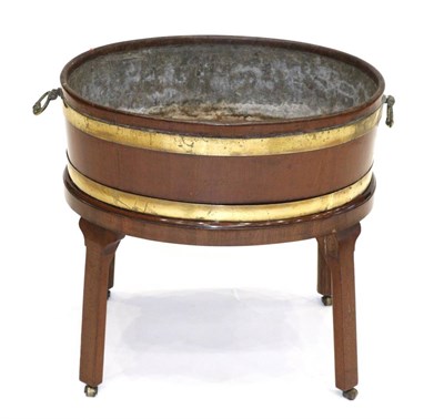 Lot 860 - A George III Mahogany and Brass Bound Wine Cooler, late 18th century, the interior lead lined,...