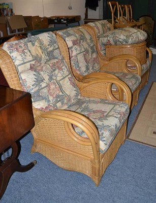 Lot 815 - A collection of conservatory furniture comprising: three caned easy chairs with upholstered...