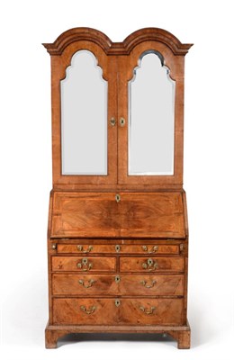 Lot 872 - A George I Walnut Bureau Bookcase, early 18th century, the double domed top above mirror doors...