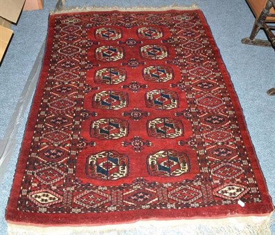 Lot 855 - A red ground rug