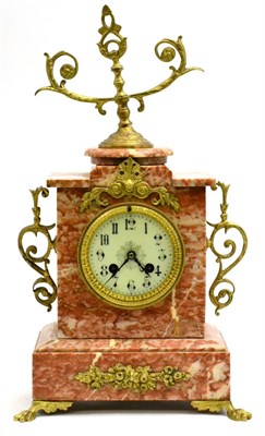 Lot 5137 - A pink marble striking mantel clock
