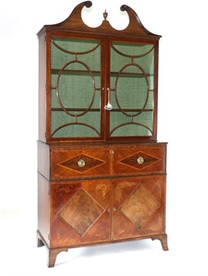 Lot 894 - A George III Mahogany and Tulipwood Banded Secretaire Bookcase, circa 1800, the swan neck...