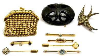 Lot 5215 - A group including four gem set bar brooches, two stick pins, a carved and pierced jet brooch, a...