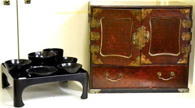 Lot 5232 - Japanese lacquered table cabinet and an ebonised supper set on tray (2)