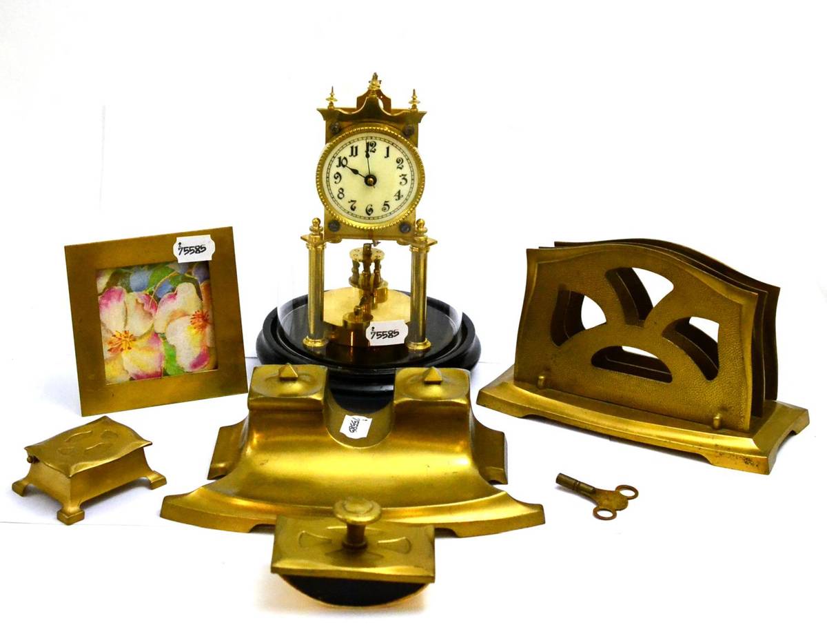 Lot 5274 - An anniversary clock under a glass dome and a five piece frosted brass desk set comprising of...