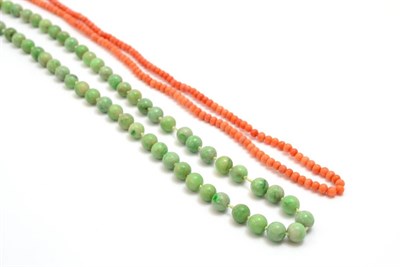 Lot 5327 - A jade bead necklace, length 70cm and a coral bead necklace, length 66cm approximately (2)