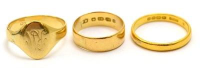 Lot 5335 - A 9ct gold signet ring, a 22ct gold wedding band and an 18ct gold wedding band (3)