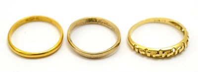 Lot 5337 - A 22ct gold wedding band together with two 9ct gold rings