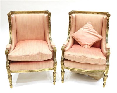 Lot 916 - A Pair of Louis XV Style Carved Giltwood Fauteuils, upholstered in faded pink fabric, with a...