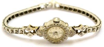 Lot 5357 - A lady's diamond set wristwatch, stamped '14K', retailed by Bucherer