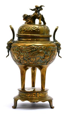 Lot 5454 - A Japanese bronze koro, raised on three tall feet, with twin handles and a lift off cover