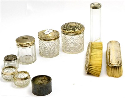 Lot 5486 - Seven various cut glass toilet jars with silver covers and two silver backed clothes brushes