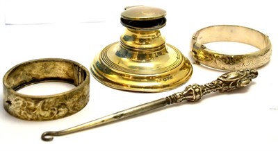 Lot 5516 - Silver inkwell, two silver bangles and a button hook