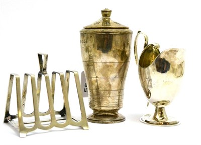 Lot 5545 - Art Deco silver caster, Art Deco toast rack and silver cream jug (3)