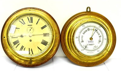 Lot 5563 - A ship's type bulk head timepiece and a ship's type aneroid barometer retailed by John Barker & Co