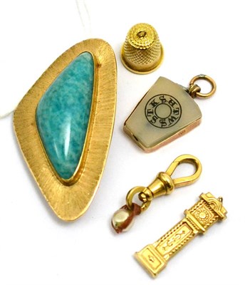 Lot 5596 - A brooch/pendant with blue stone (stick a.f.), together with four 9ct gold and other charms (5)