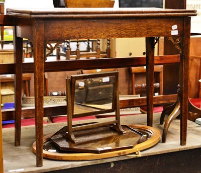 Lot 6013 - A George III oak fold-over tea table pierced with angle brackets on square tapering legs,...