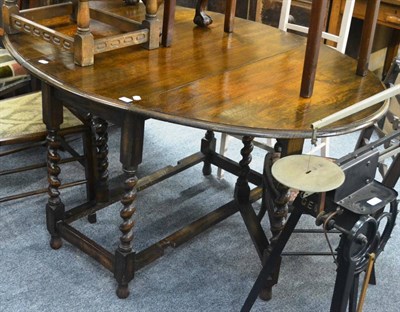 Lot 6017 - An oak gateleg table with barley twist supports