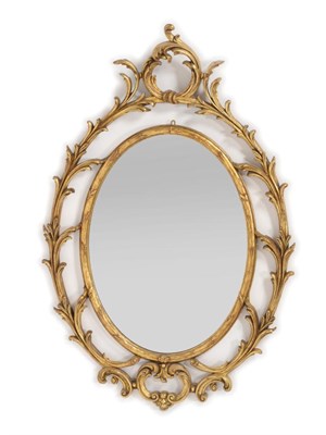 Lot 967 - A George III Style Carved Giltwood Mirror, the oval plate with an acanthus frame and C scroll plume