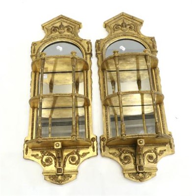 Lot 975 - A Pair of 19th Century Gilt and Gesso Mirrors, the oval plates within a leafy border with three...