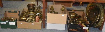 Lot 6097 - A large group of brass including 19th century candlesticks, alms dishes, gongs etc (in four boxes)