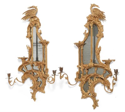 Lot 979 - <div><strong>A Pair of Carved Giltwood Two-Branch Girandoles</strong>,of asymmetric form, the...