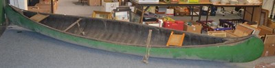 Lot 6145 - An early 20th century large canoe, possibly North American, the bent rib frame covered in green...