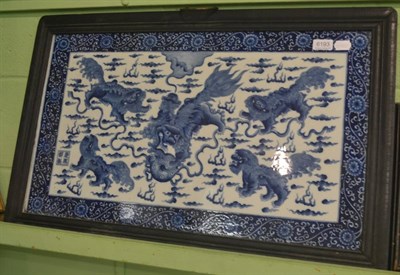 Lot 6193 - A large Chinese blue and white panel decorated with dogs of fo in a hardwood frame