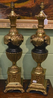 Lot 6259 - A pair of modern gilt metal table lamp bases with urn stems and scroll feet