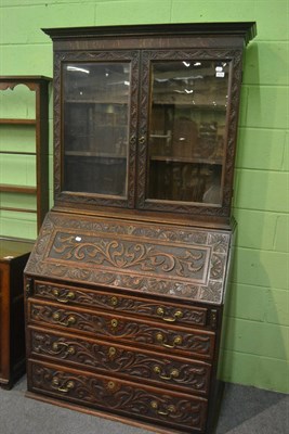 Lot 6270 - Victorian heavily carved oak bureau bookcase with glazed top