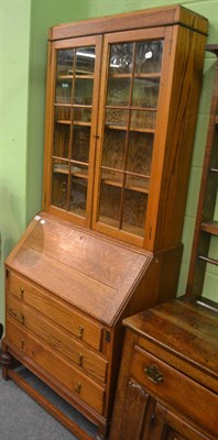 Lot 6272 - Early 20th century light oak bureau bookcase