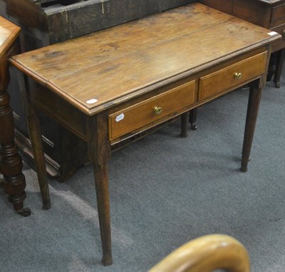 Lot 6295 - A small George II style oak writing table, the shaped oblong top over two frieze drawers, on turned