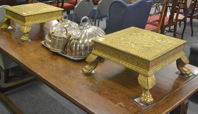 Lot 6307 - A pair of decorative brass mounted embossed stands