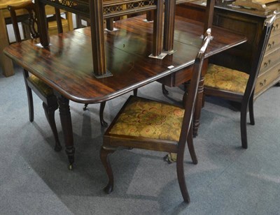 Lot 6342 - A Victorian mahogany drop leaf dining table raised on brass casters, together with four...