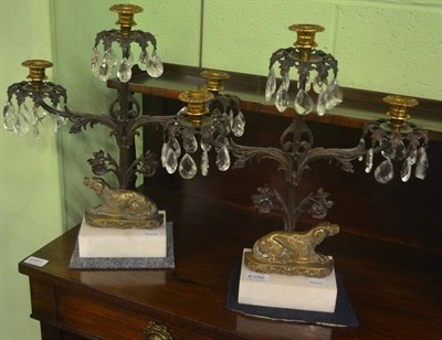 Lot 6390 - A pair of patinated bronzed three light candelabra