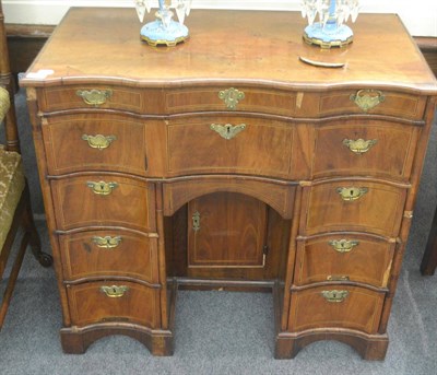 Lot 6395 - An early 19th century mahogany kneehole desk, the scallop shaped top above a scalloped...