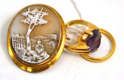 Lot 53 - 22ct gold wedding band, 18ct gold and amethyst ring and a 9ct gold framed shell cameo (3)