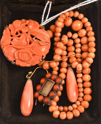 Lot 86 - A carved coral floral brooch, a coral set mourning brooch, a strand of coral beads and a pair...