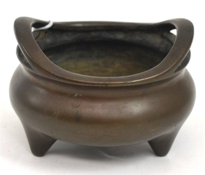 Lot 112 - Chinese bronze tripod censer with twin handles and Xuande sixteen character mark to the base,...