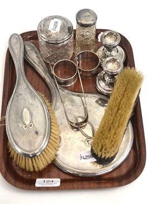 Lot 124 - A tray of silver including napkin rings, sugar tongs, silver lidded jars, etc