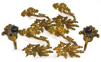 Lot 132 - Four 19th century French gilt-bronze curtain tie backs, with two others (6)