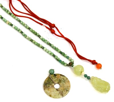 Lot 222 - A jade pendant on assorted green bead necklace and a jade disk pendant on card